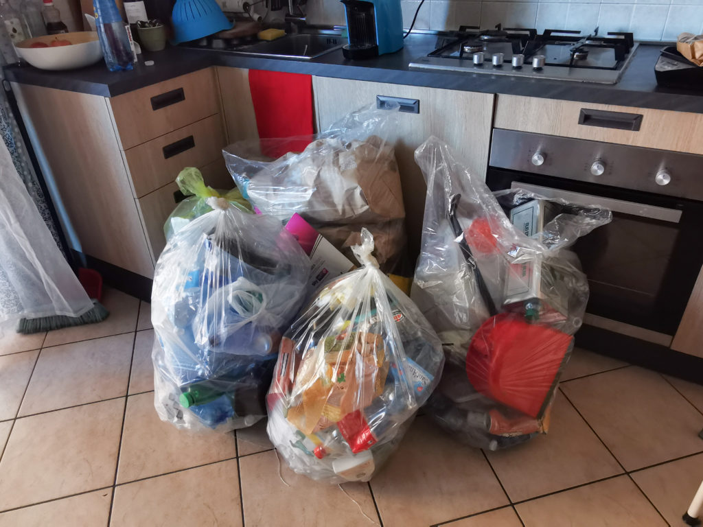 4 big bags filled with plastic trash in the kitchen of sabrina. 